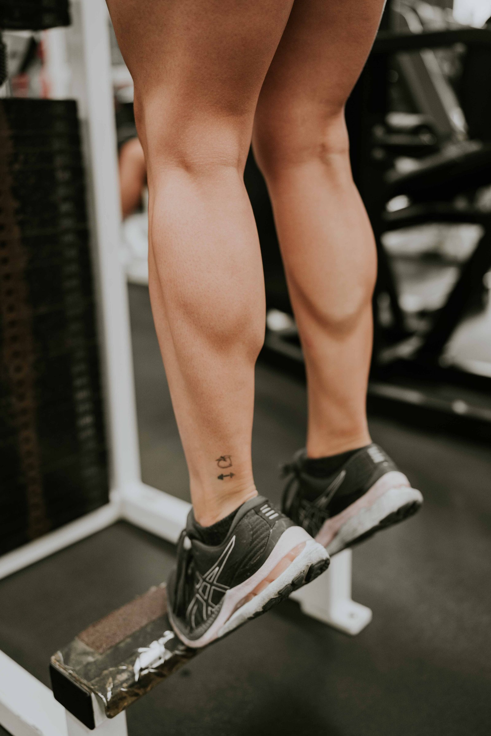Person performing a calf raise exercise to strengthen the tibialis posterior tendon