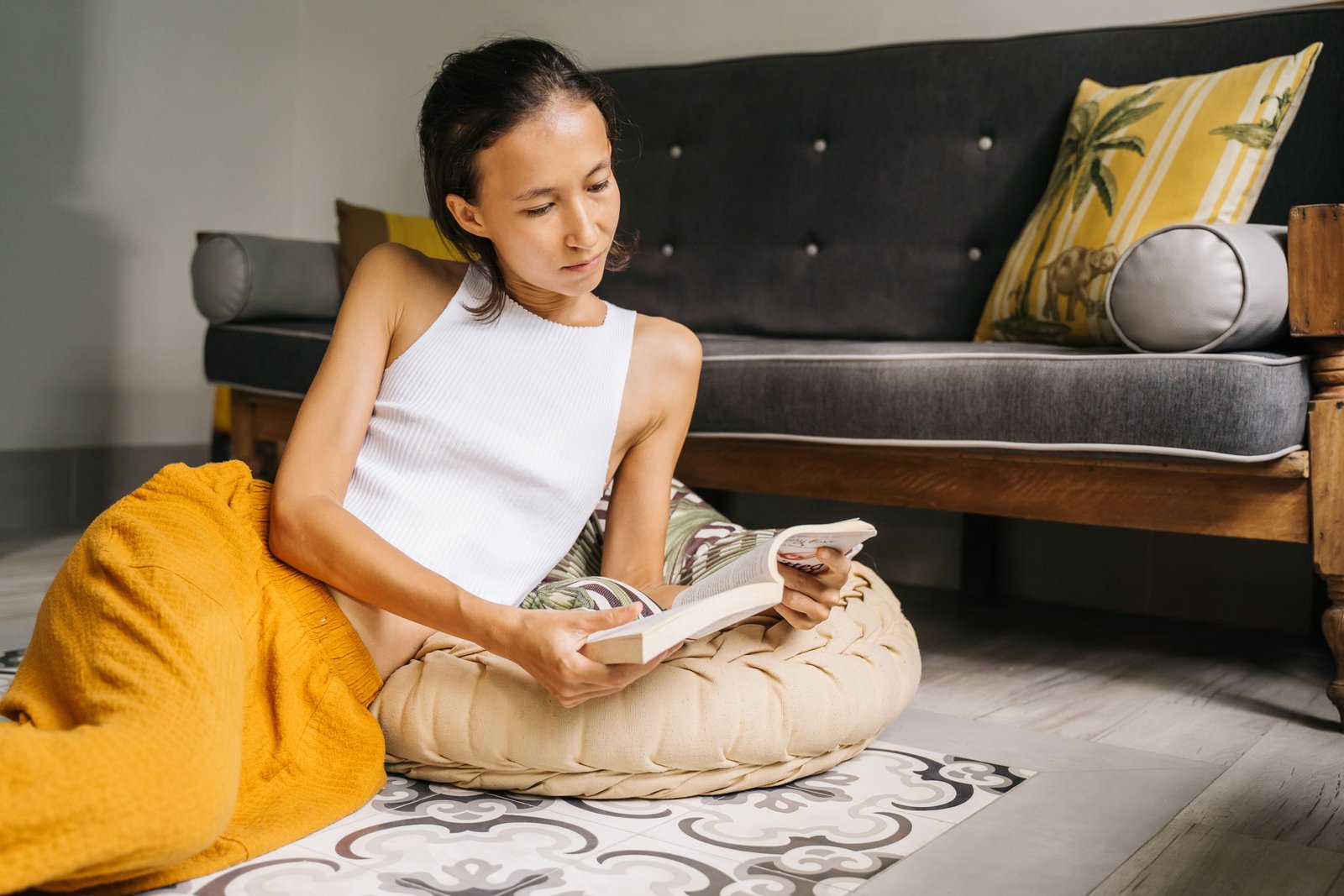 Person sitting carefully on a supportive cushion while recovering from a tailbone injury