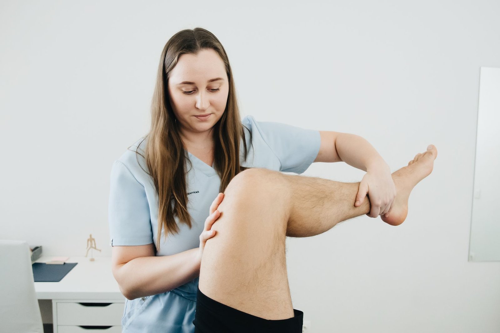 Physiotherapist delivering guided shin pain treatment