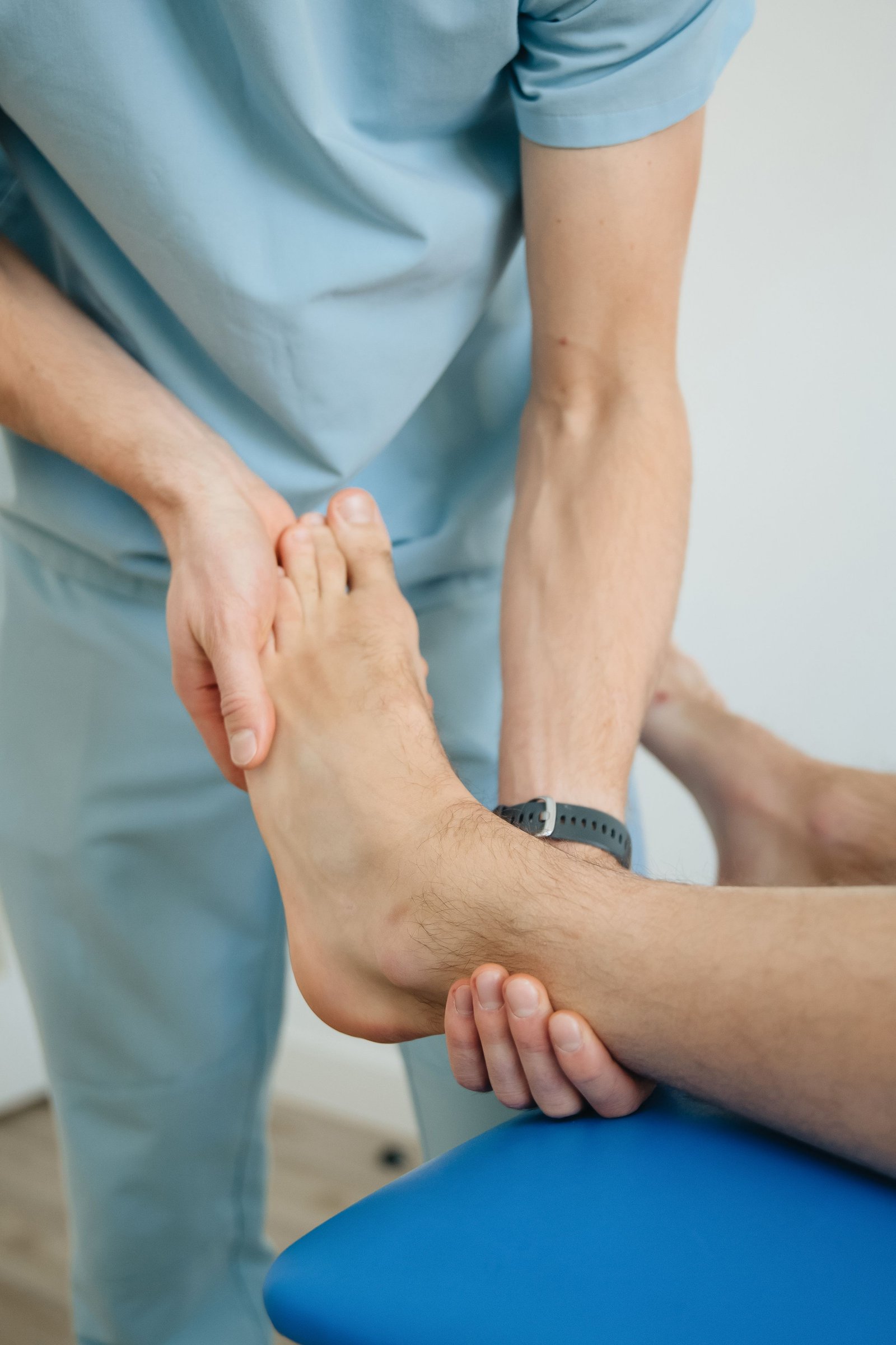 Clinician assessing a patient's inner ankle following a deltoid ligament sprain
