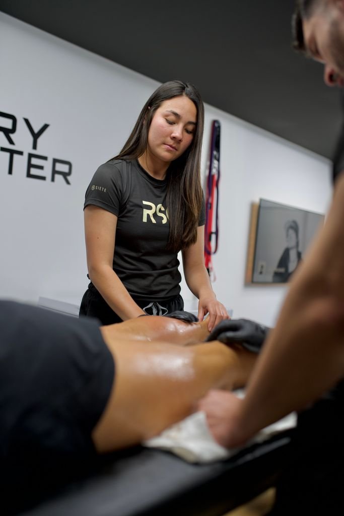 Sports therapist providing a sports massage session focused on muscle therapy