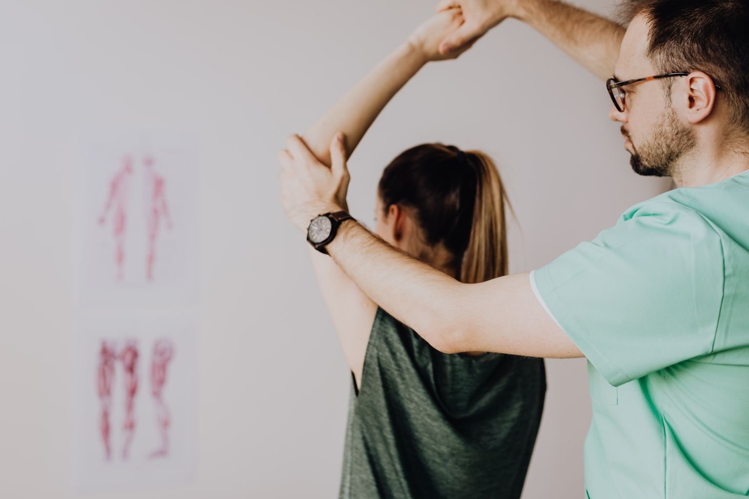 Clinician assessing a patient's elbow to build a golfers elbow exercises plan