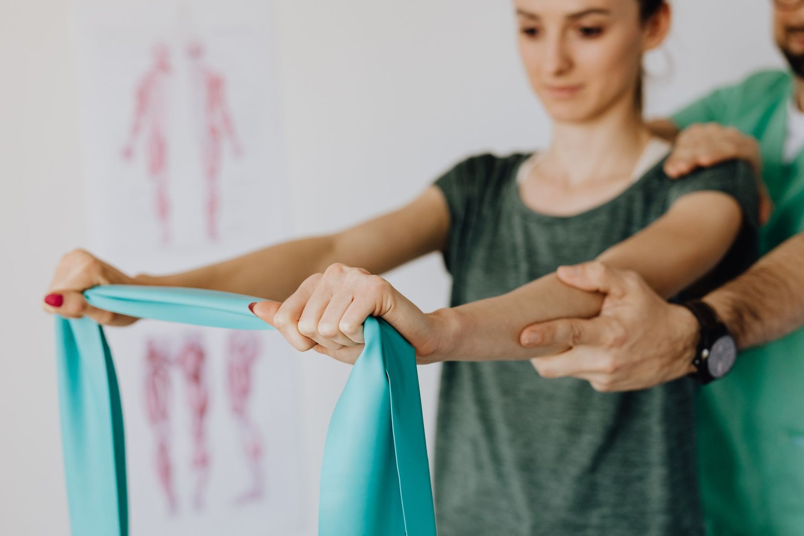 Clinician guiding an arm exercise as part of ulnar collateral ligament injury rehab