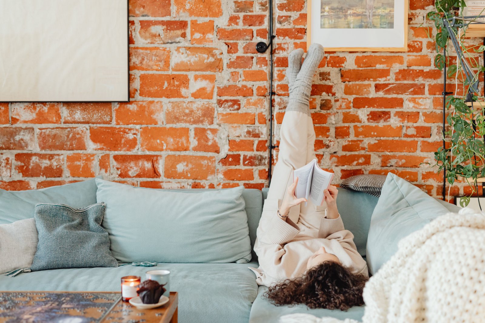 Person lying down with a rolled towel behind the neck for cervicogenic headache treatment at home
