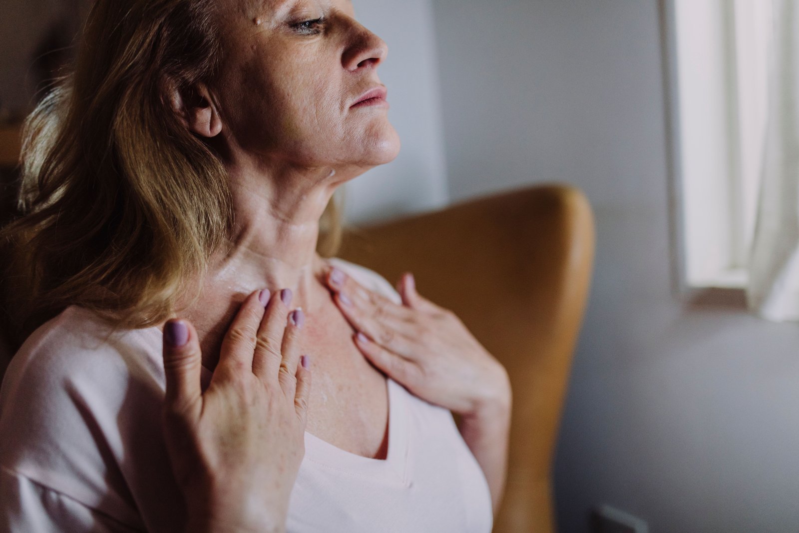 Person doing gentle self-massage on neck to relieve pain at base of skull