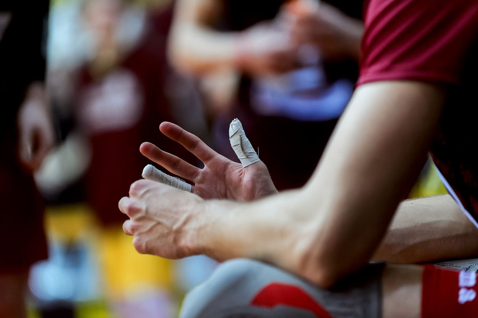 Kinesiology tape being applied to a finger as part of A2 pulley injury rehabilitation and protection.