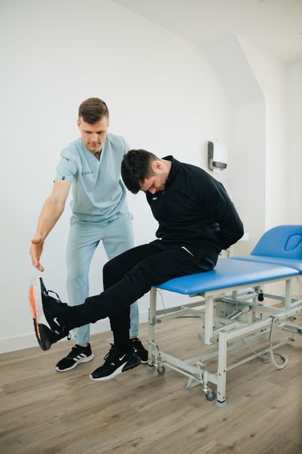Physiotherapist guiding gentle lower back pain exercises during the acute phase