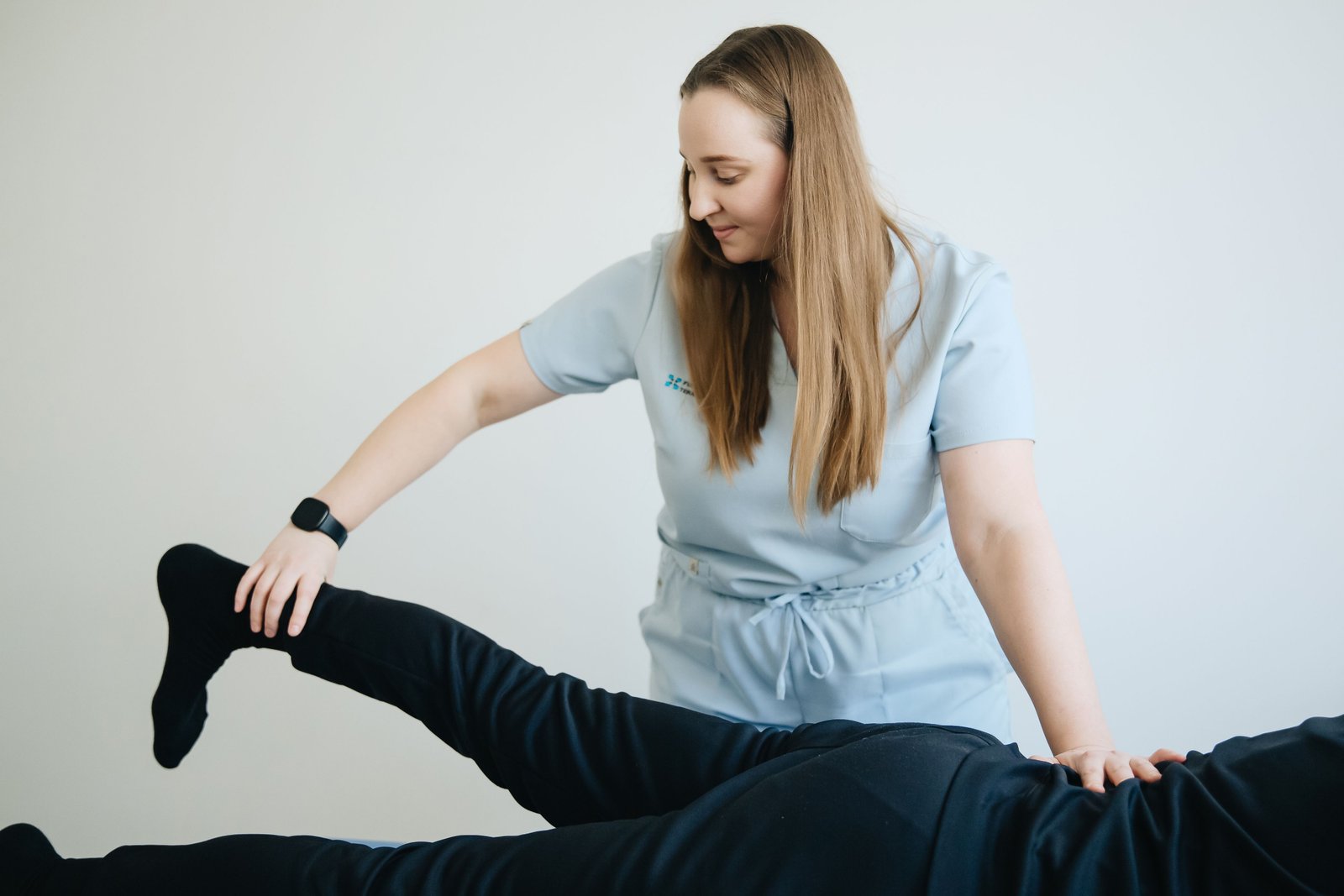 Physiotherapist assessing a patient to identify the cause of groin pain