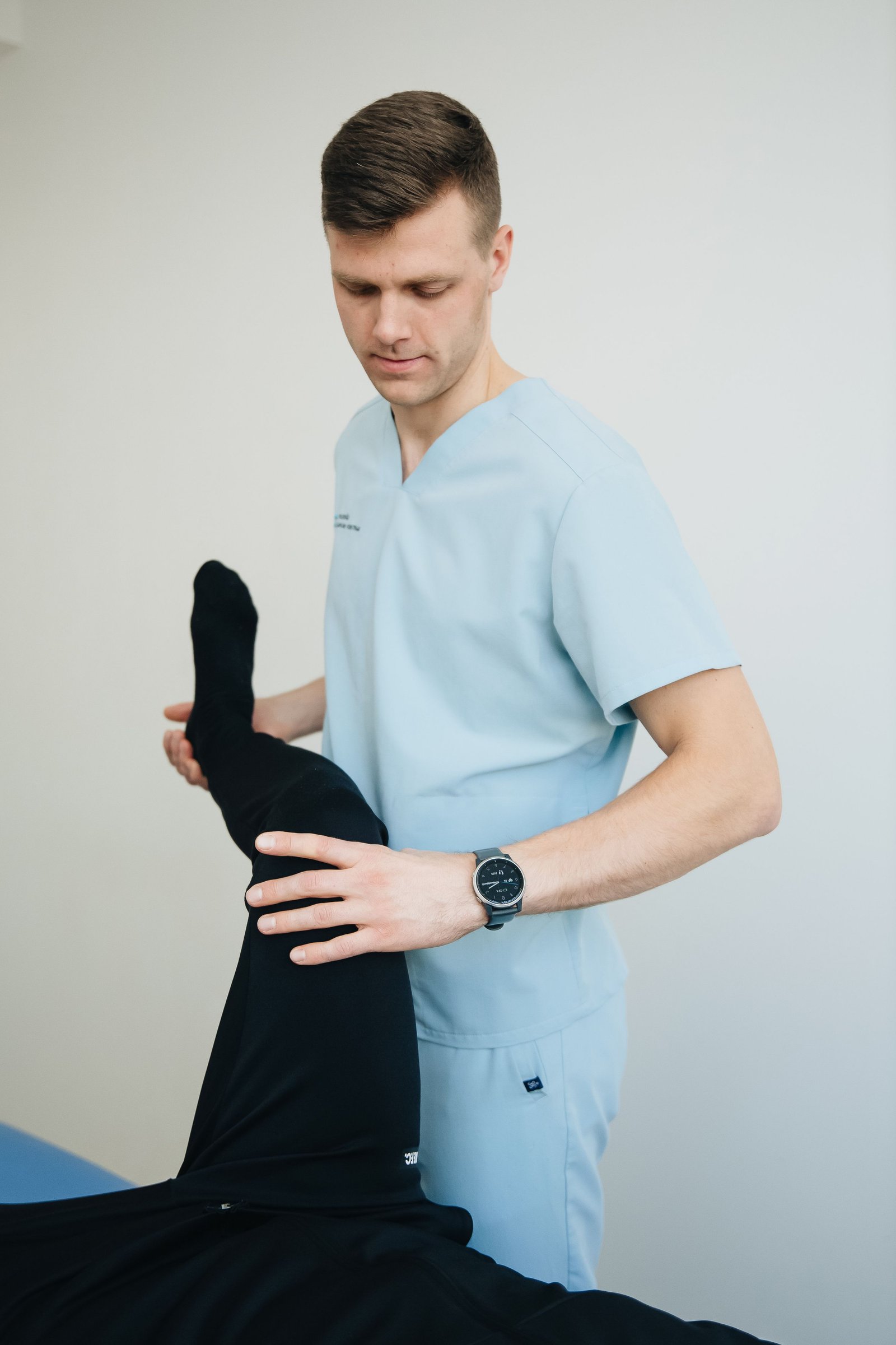 Physiotherapist guiding a strengthening exercise to address adductor pain