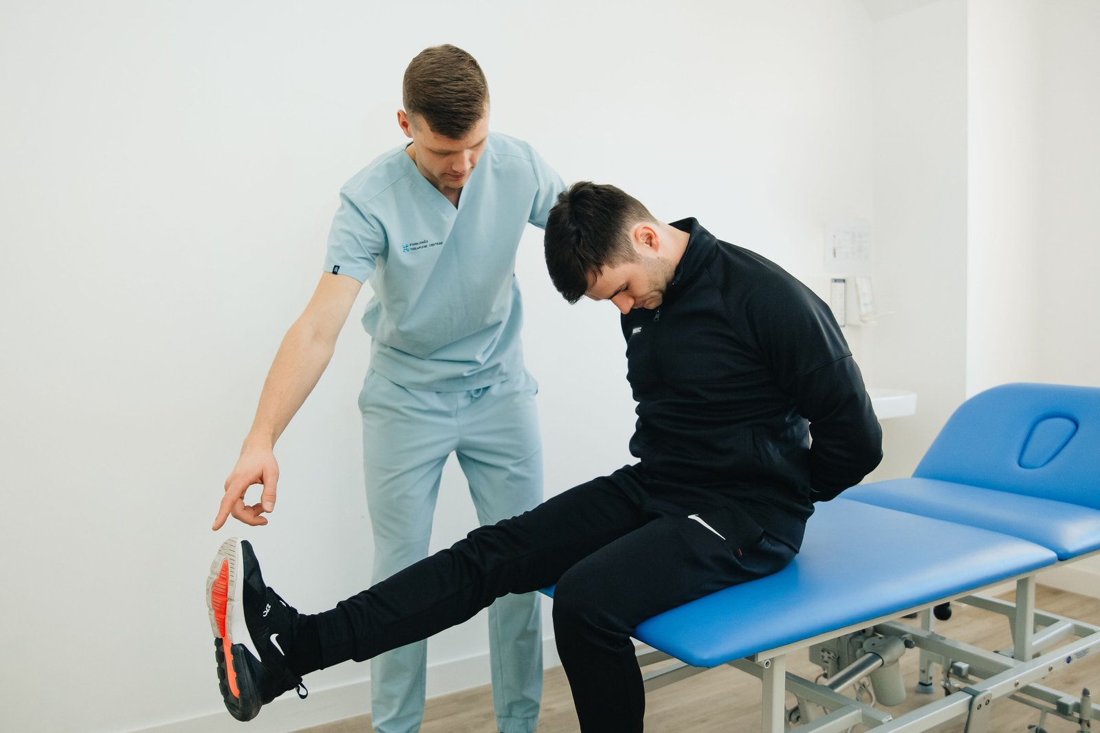 Physiotherapist guiding an athlete through a throwing-specific baseball shoulder exercises plan