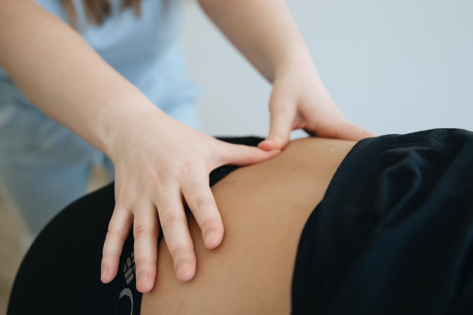 Therapist providing a lower back massage, a treatment often used for ql muscle pain