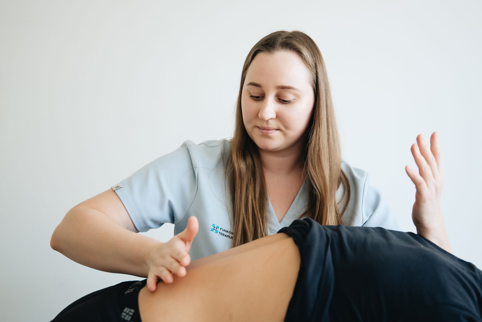 Therapist providing supportive treatment during physical therapy for sports hernia rehabilitation