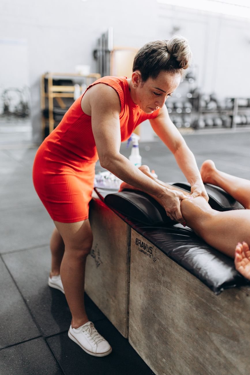 Physiotherapist assessing a client's calf as part of calf strain rehab