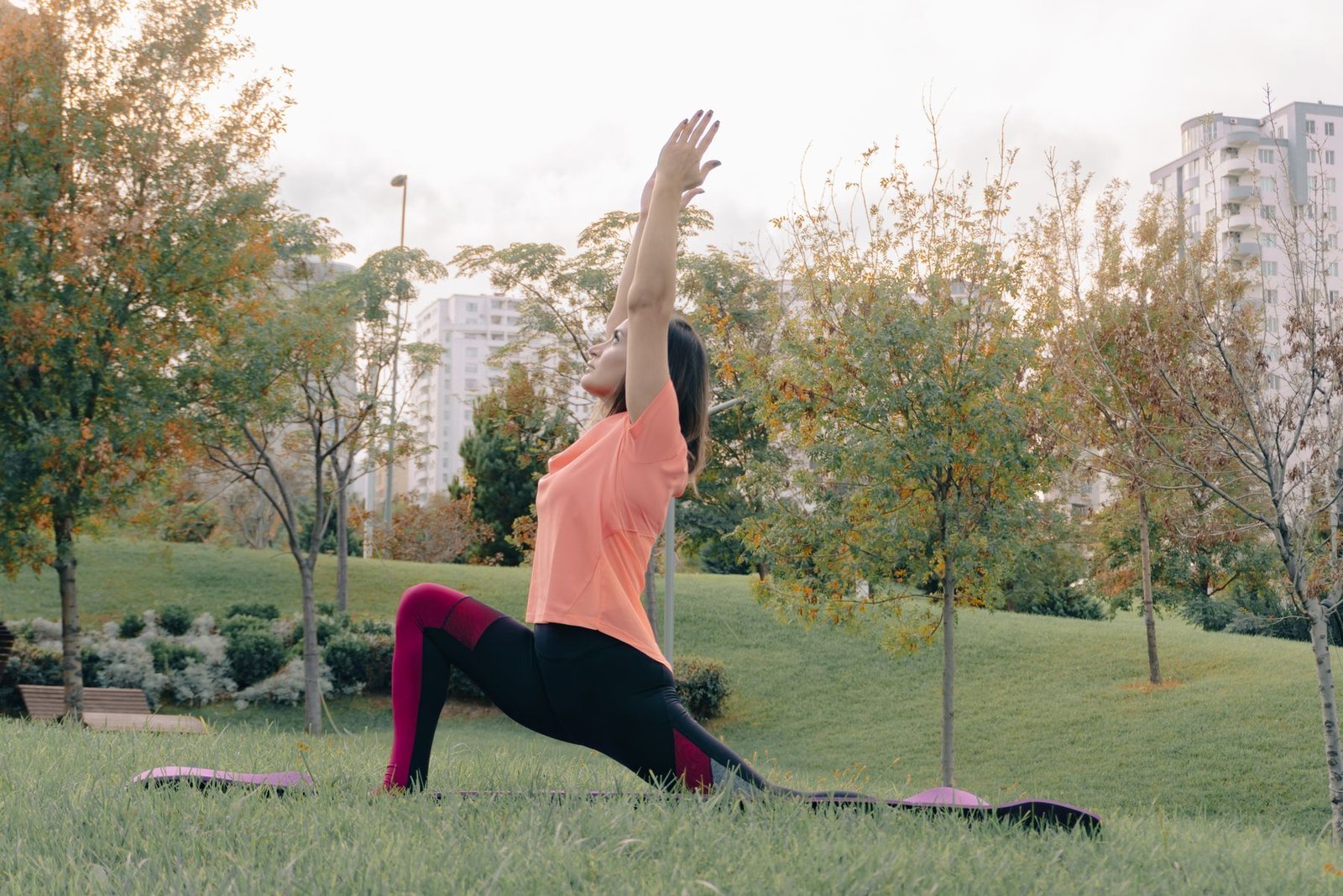 Woman performing a hip flexor stretch, relevant to managing psoas muscle pain