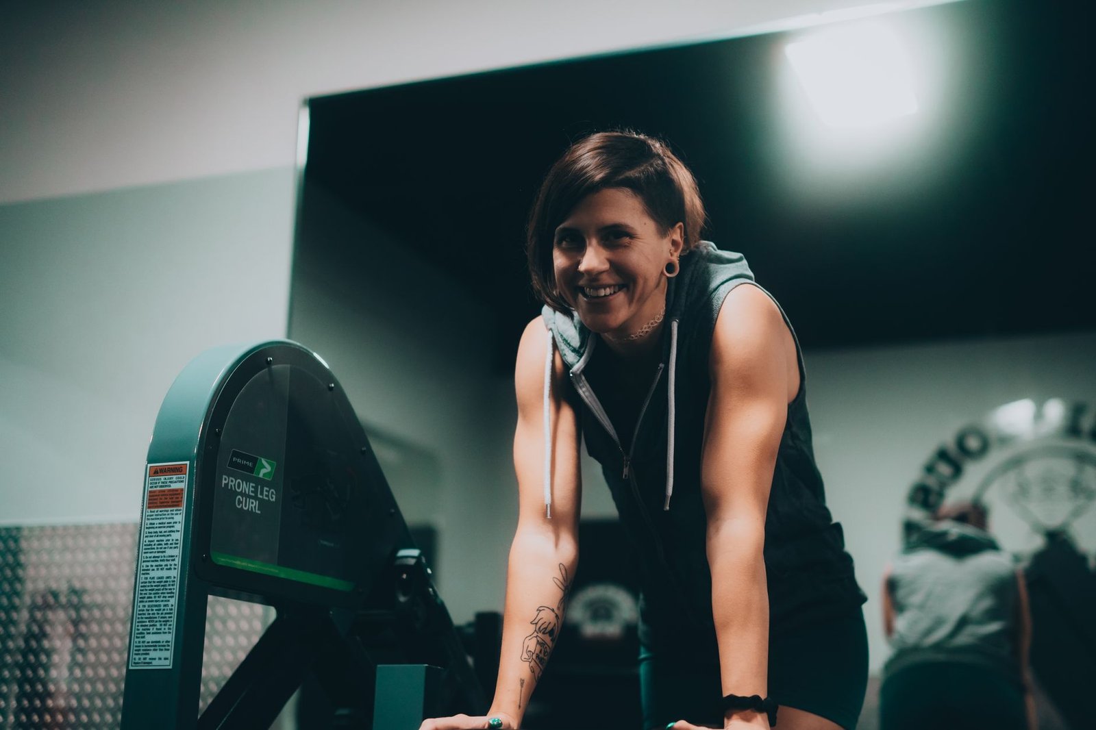 Person using a leg curl machine as part of structured hamstring rehab exercises focused on eccentric strength