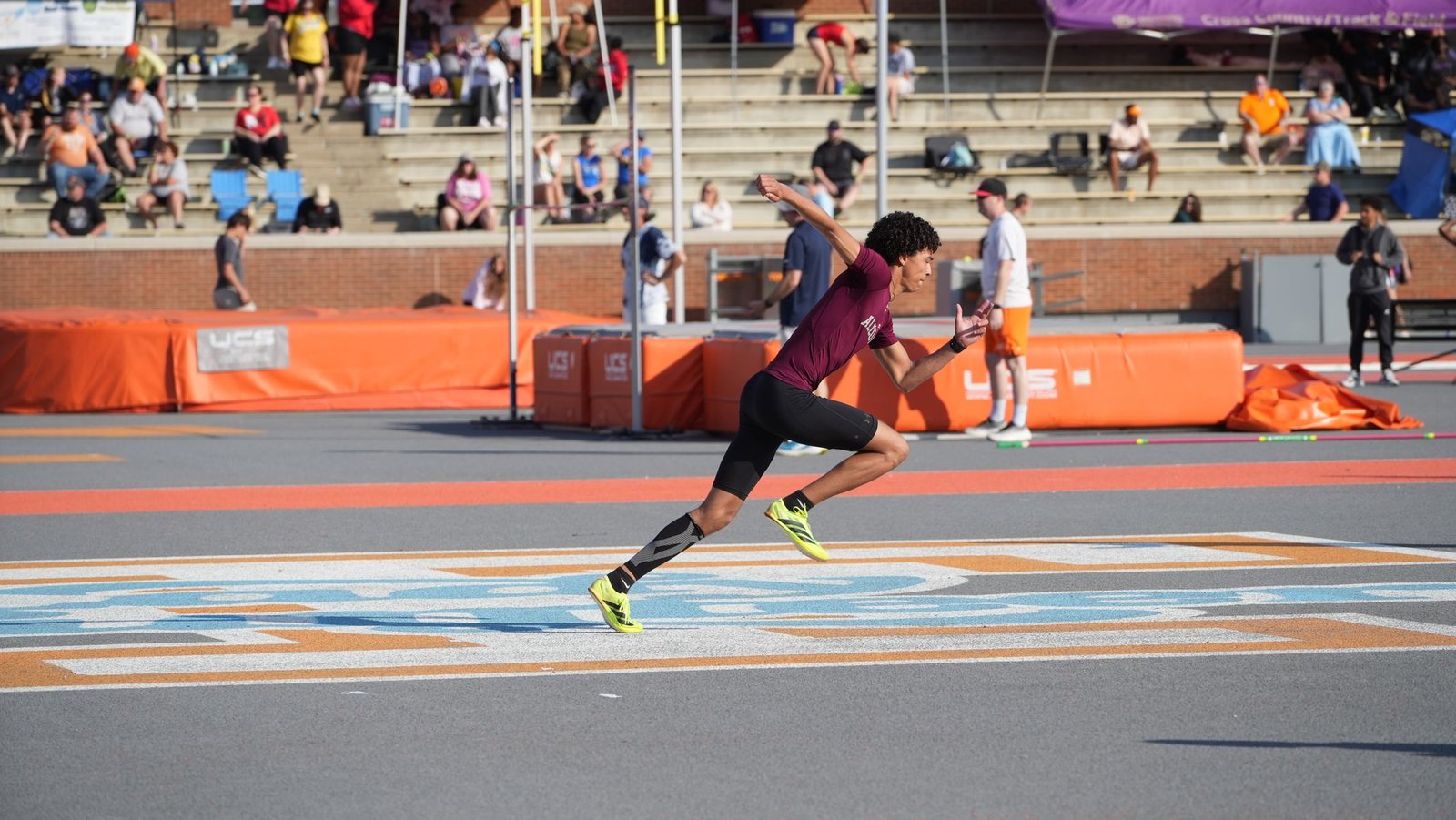 Athlete sprinting on a track, representing the later stage of grade 2 quad strain recovery time