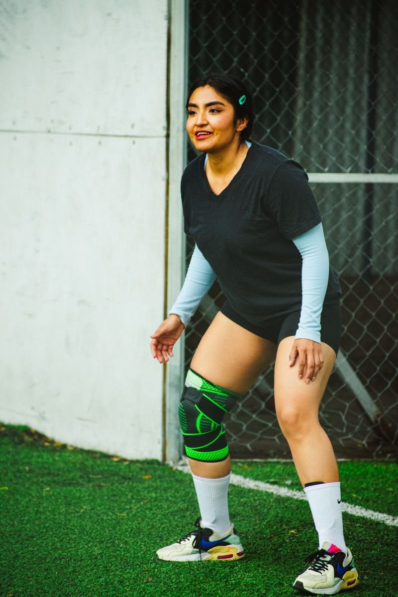 An athlete wearing a knee brace during recovery, illustrating early-stage protection as part of MCL physical therapy exercises.