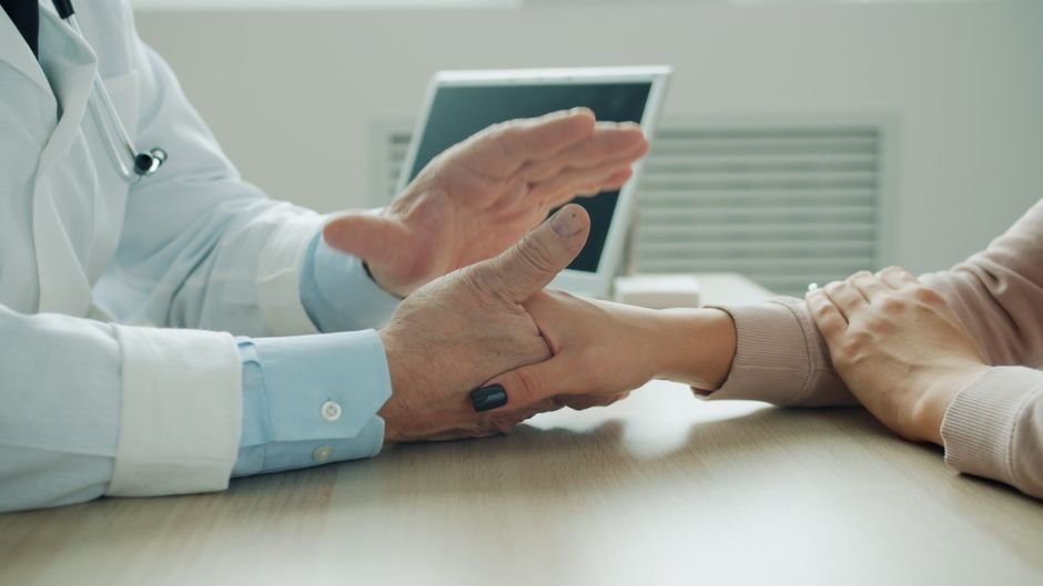 Clinician performing a wrist injury assessment following a FOOSH injury
