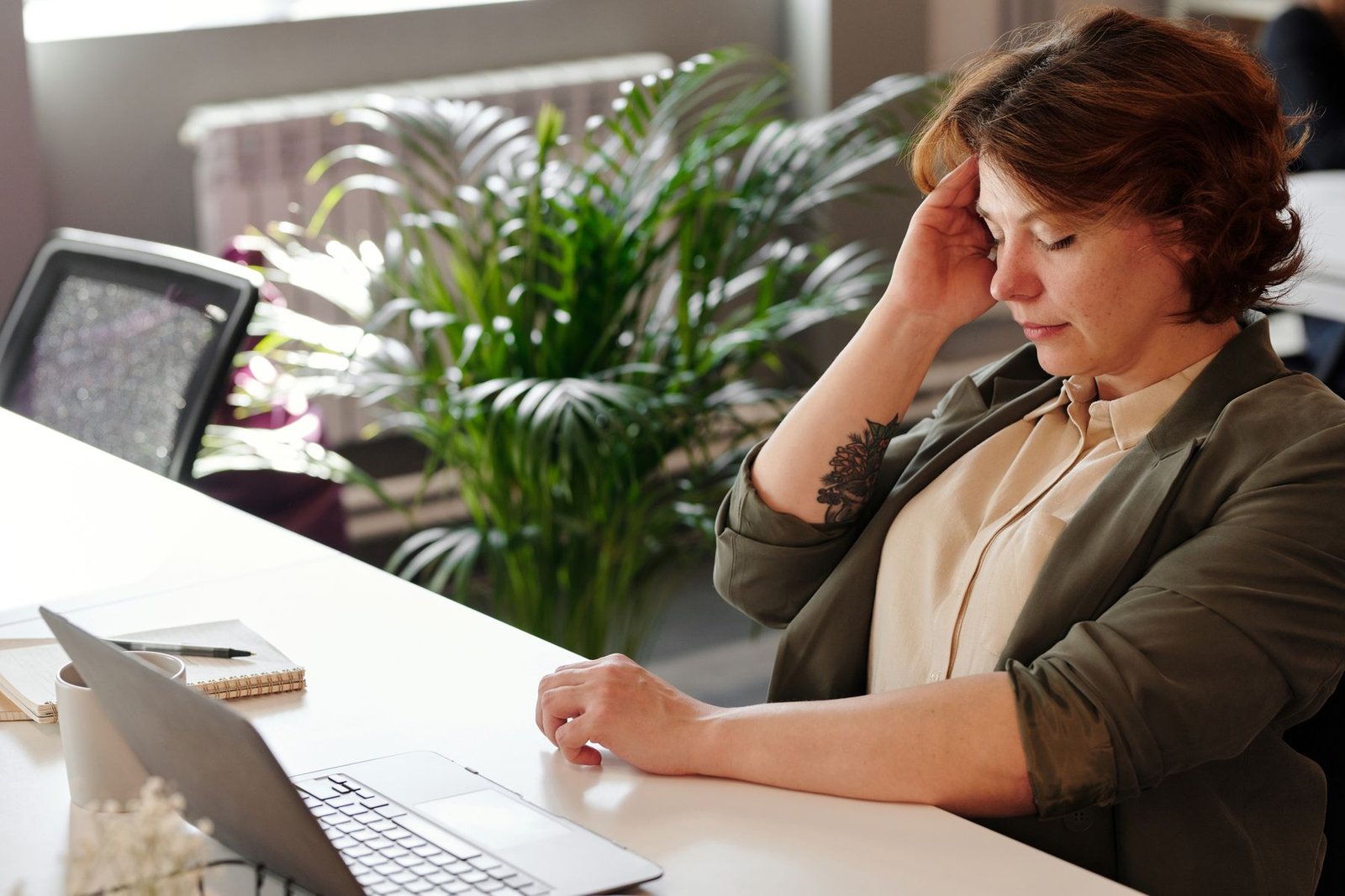 Person at a desk with poor posture, a common contributor to ql muscle pain