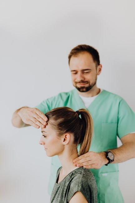 Physiotherapist supporting whiplash neck recovery following a concussion from whiplash incident