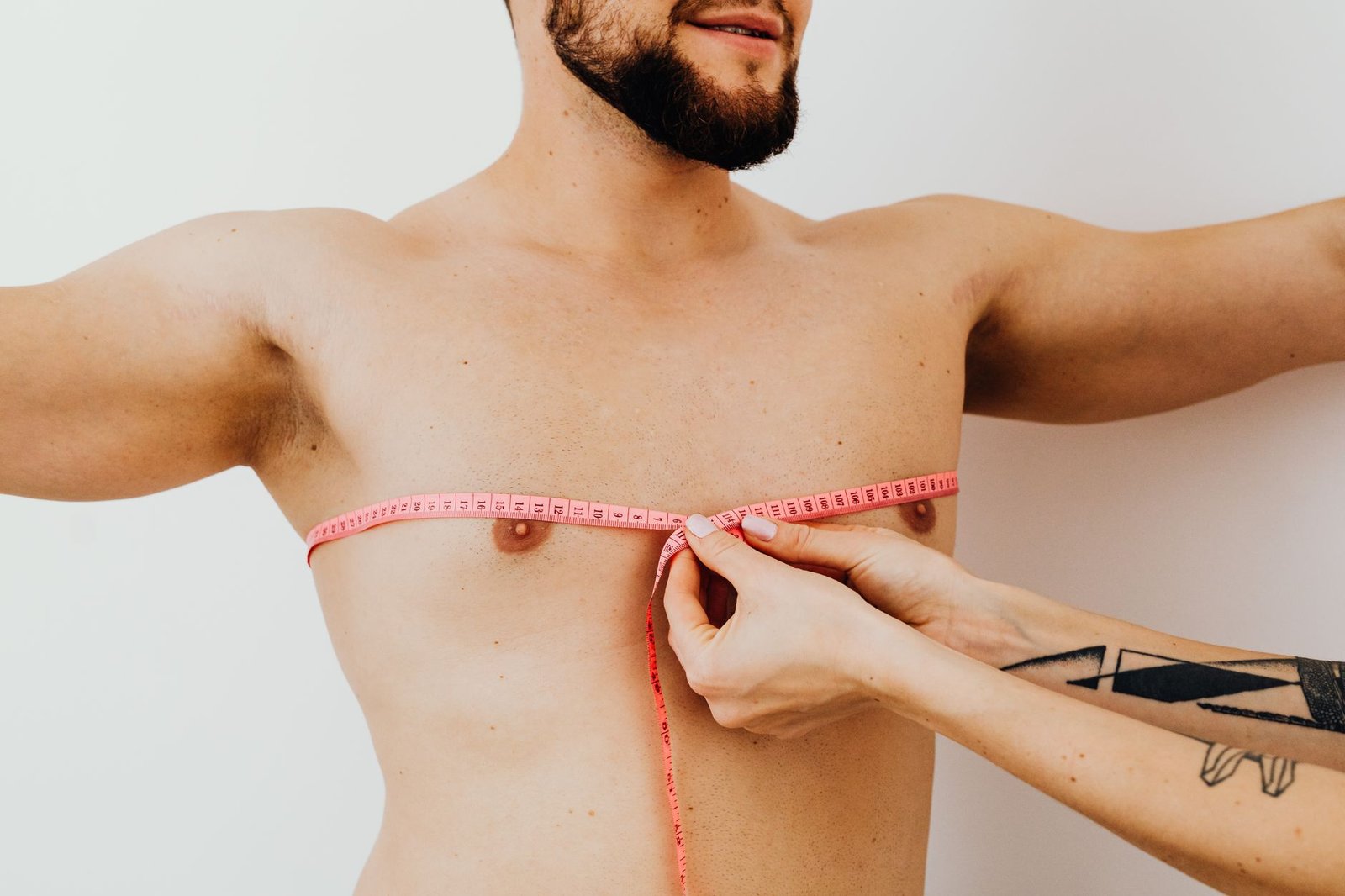 Clinician assessing a client's chest muscle for signs of a pec strain