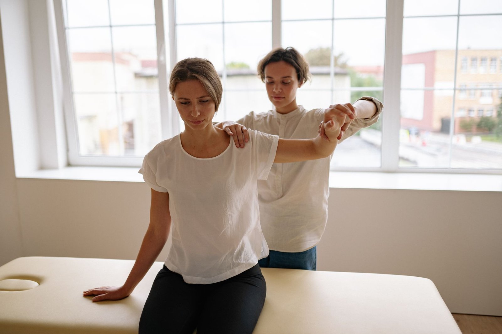 Person doing a shoulder blade stretching technique to support recovery from a rhomboid strain