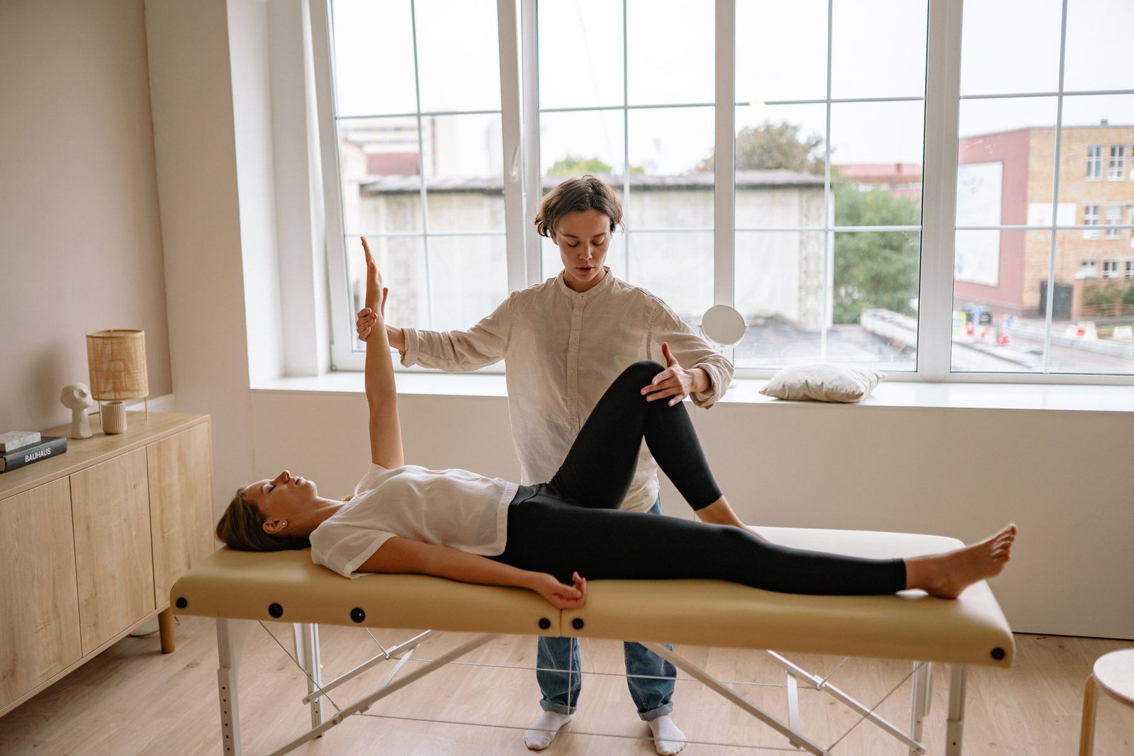 Clinician providing a therapy session, relevant to quadriceps strain assessment and treatment