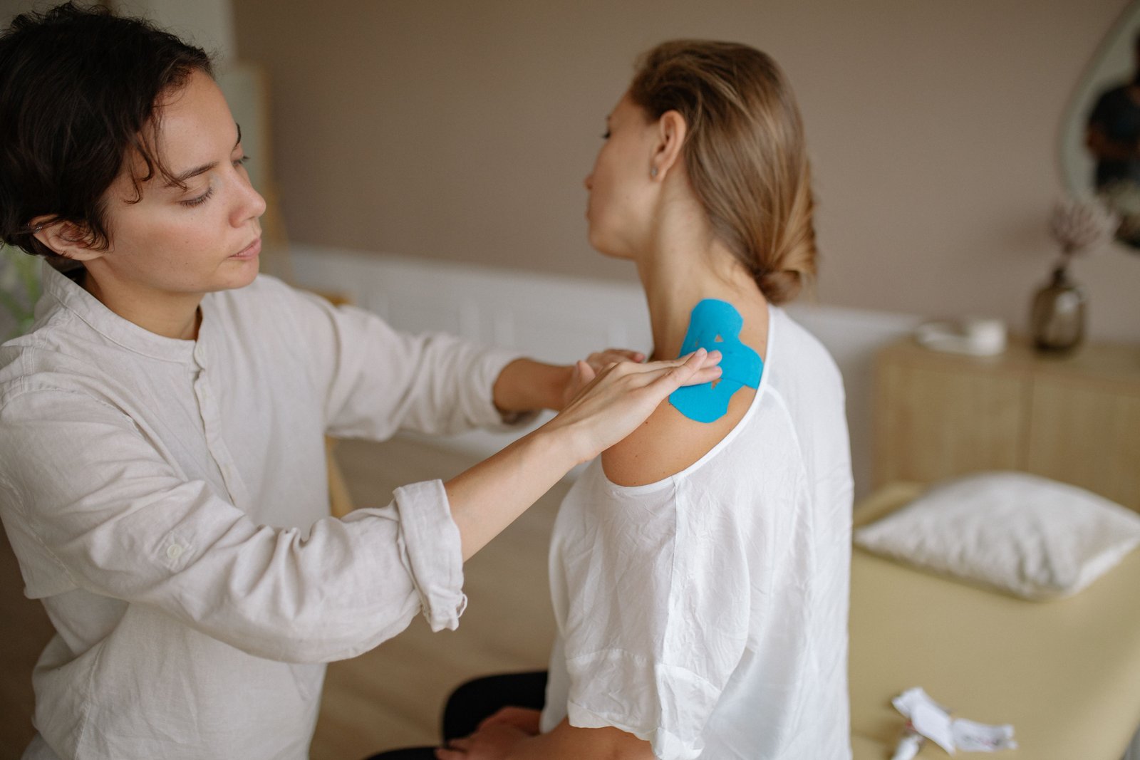 Physiotherapist assessing an athlete's shoulder as part of joint hypermobility and injury risk care