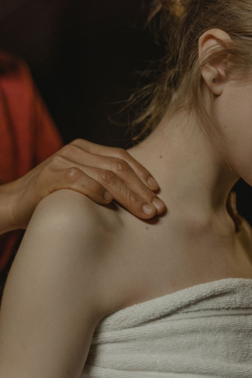Therapist performing upper trapezius massage therapy to relieve trap pain