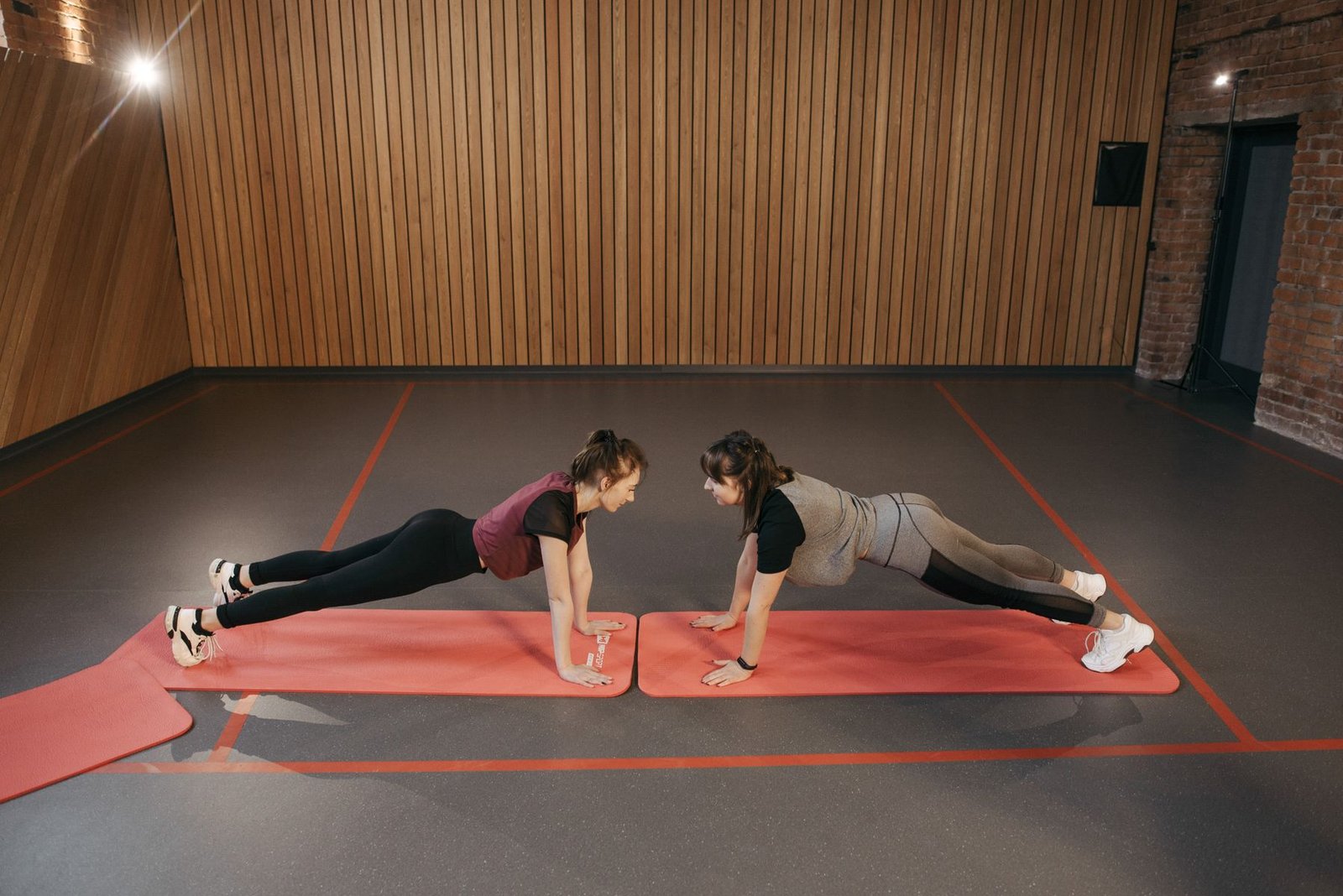 People performing a plank for core strength, an exercise often used to help manage lower back pain after squats