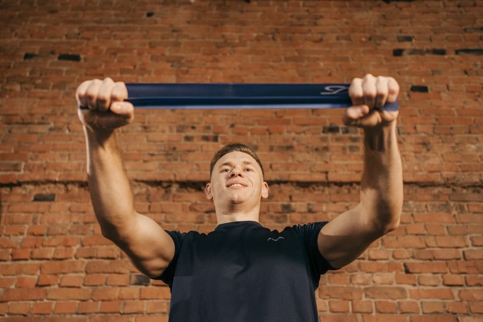 Athlete performing a progressive rotator cuff rehab strengthening exercise