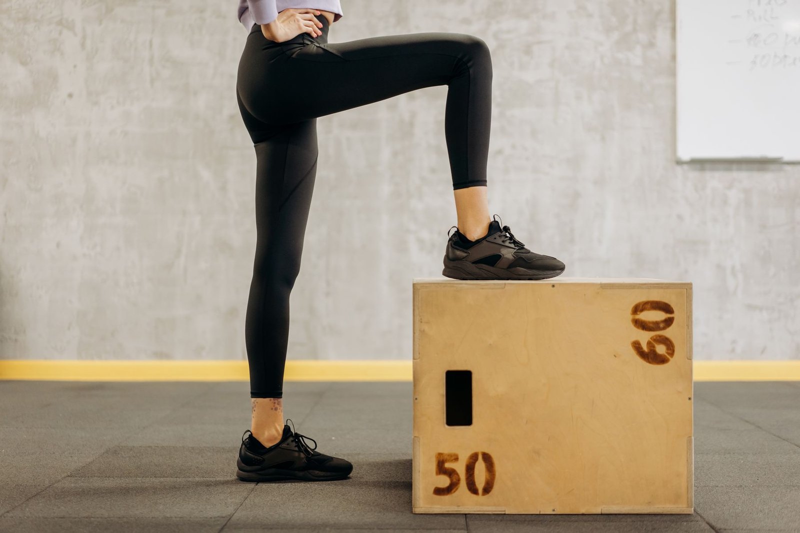 Athlete performing a step balance exercise as part of a progressive achilles tendon exercises routine