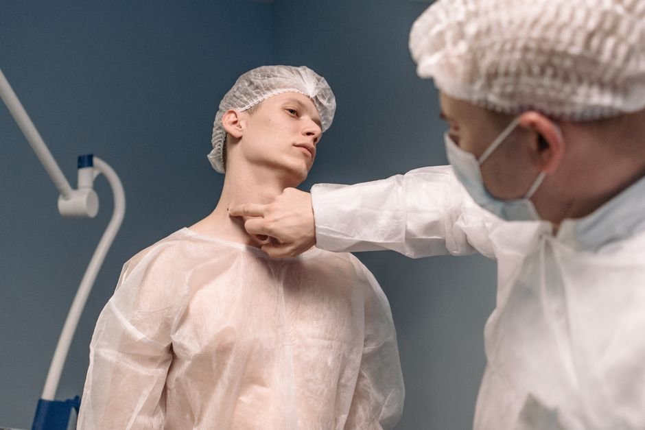 Clinician assessing neck structures relevant to guillotine BJJ injury risk