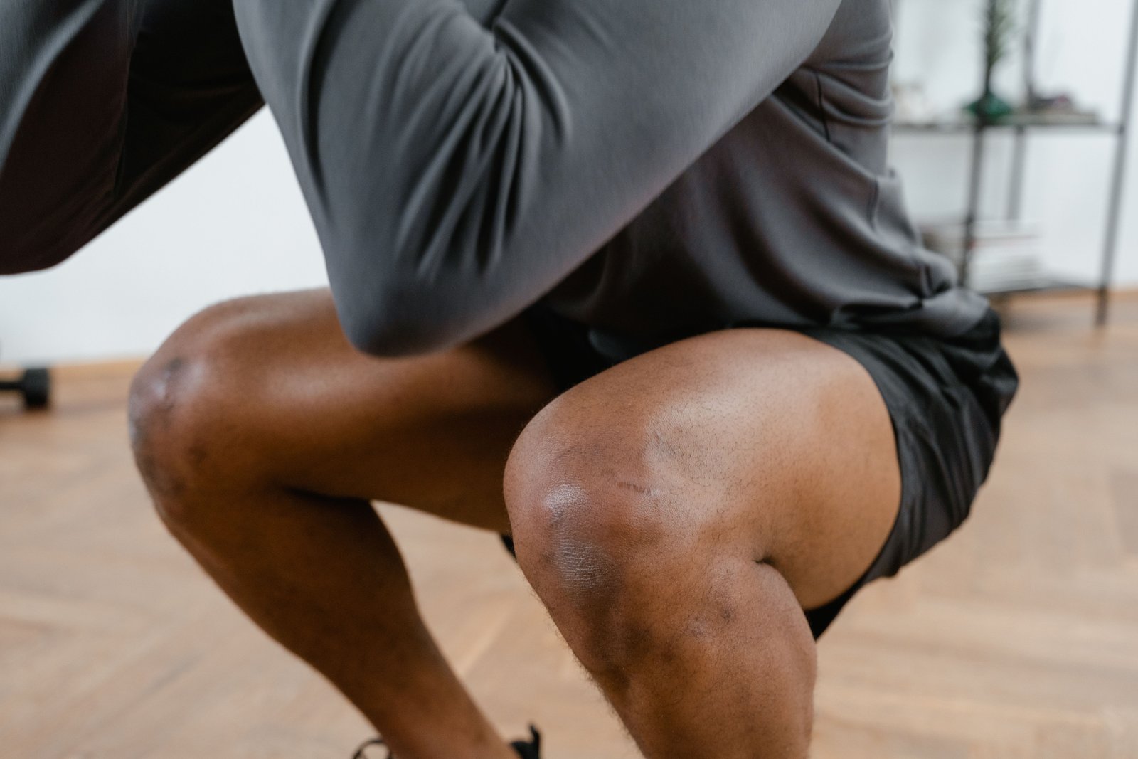 Athlete performing a squat as part of ACL recovery time strengthening phase