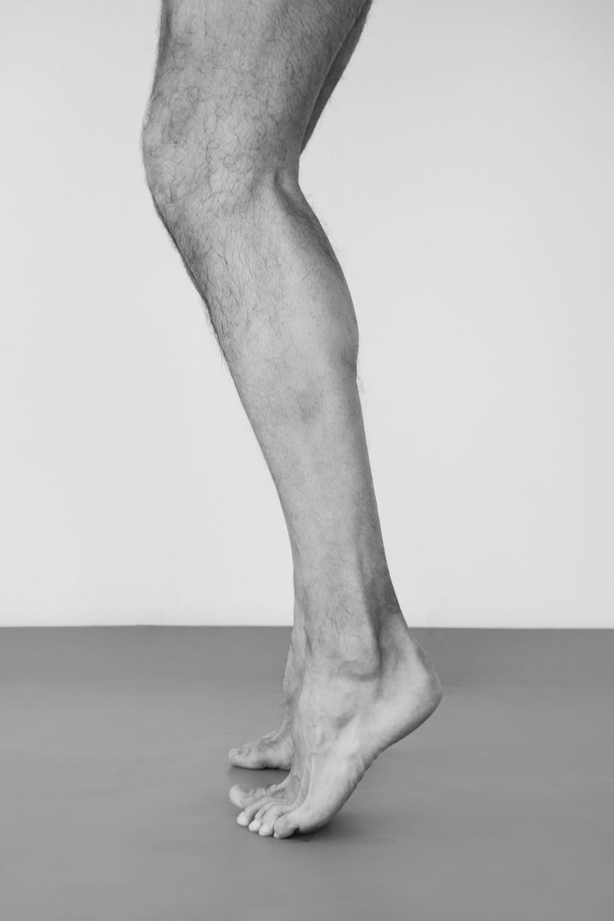 Person performing a calf raise strengthening exercise during calf strain rehab