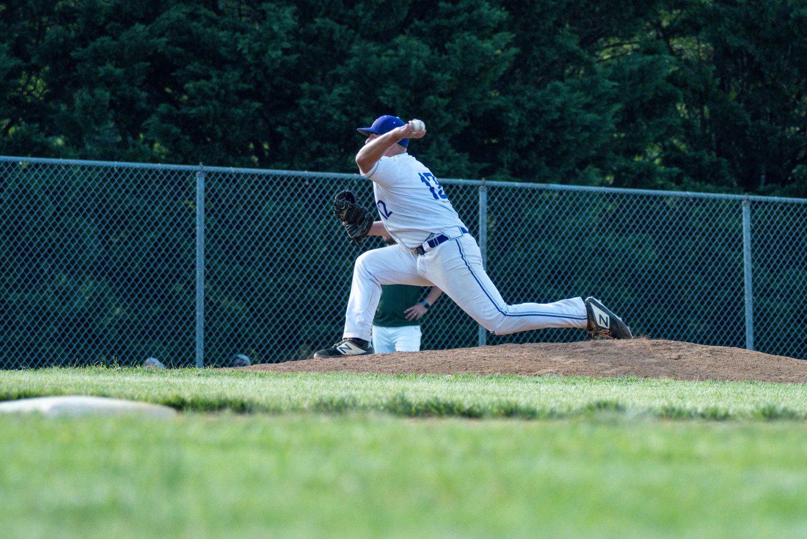 Baseball pitcher mid-throw, the motion baseball shoulder exercises are designed to support
