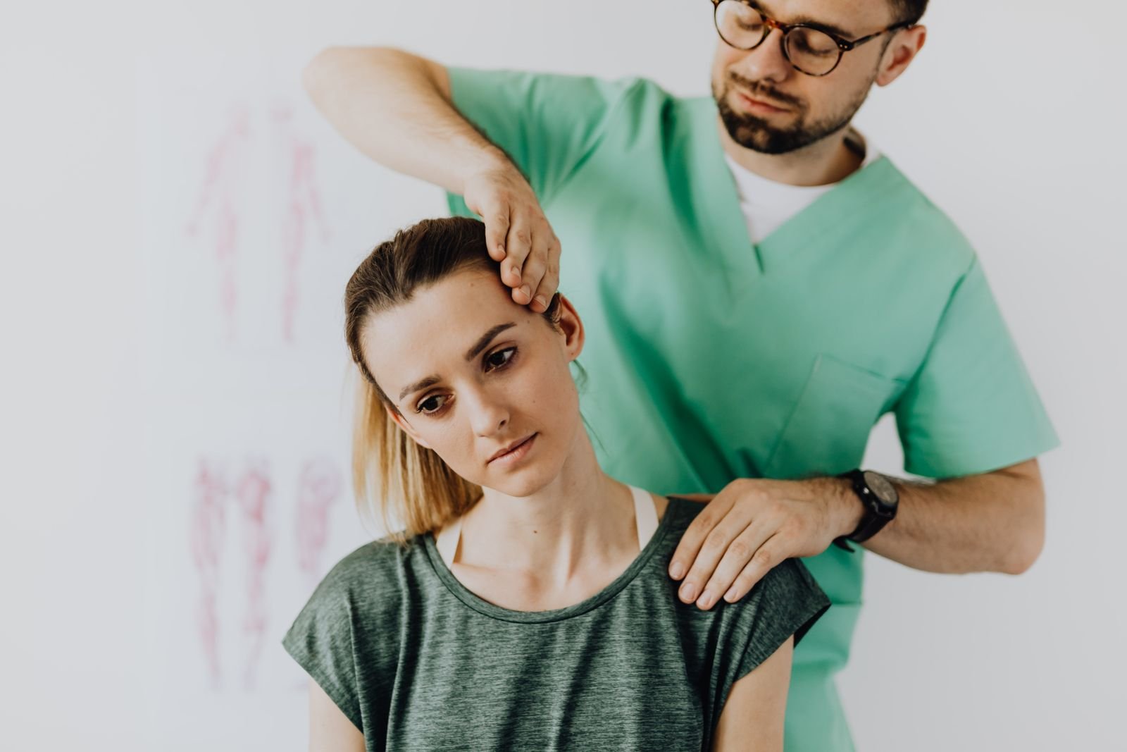 A therapist guiding a gentle side-bending neck stretch to ease neck pain left side base of skull.